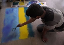 Rahul Narawane doing a landscape with rangoli at the Rangoli workshop at Indiaart Gallery