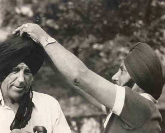 TWO EVEREST CONQUERORS - Capt Mohan Kohli tying a turban on Sir Edmund Hillary at Nandaprayag, 1977 as a symbolic 'big brother' gesture, photograph by Prem Vaidya