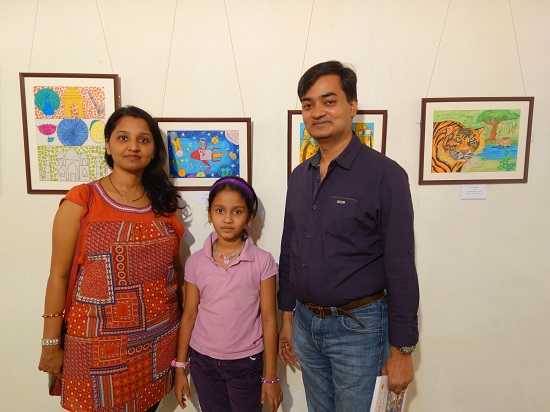 Ananya Kanungo (7 years) with her parents
in front of her painting at Khula Aasmaan - Children's Art Exhibition - Edition I
presented by Indiaat