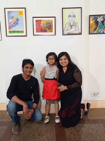 Ira Bandekar (7 years) with her parents
in front of her painting at Khula Aasmaan - Children's Art Exhibition - Edition I
presented by Indiaart