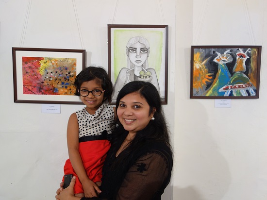 Ira Bandekar (7 years) with her mother
in front of her painting at Khula Aasmaan - Children's Art Exhibition - Edition I presented by Indiaart
