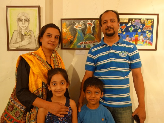 Kabir Deshpande (7 years) with his family
in front of his painting at Khula Aasmaan -
Children's Art Exhibition - Edition I
presented by Indiaart