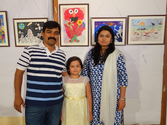 Shreya Sawant (6 years) with her parents
in front of her painting at Khula Aasmaan -
Children's Art Exhibition - Edition I
presented by Indiaart