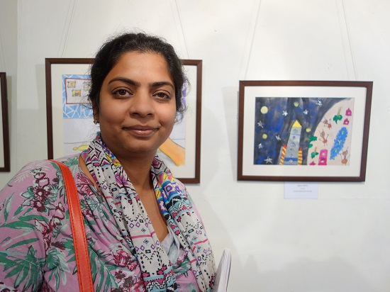 Amrita Mehta with her son's painting
at Khula Aasmaan show by Indiaart Gallery - Edition I