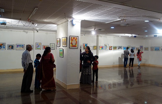 Visitors keenly looking at the paintings
by children