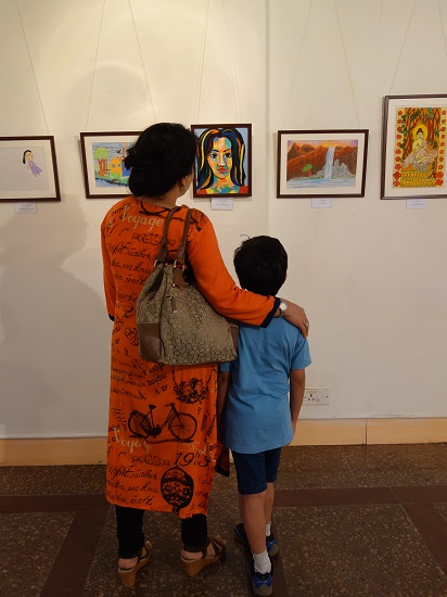 A young boy with his mother at Khula Aasmaan - Children's Art Exhibition - Edition I presented by Indiaart Gallery