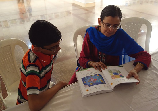 A child artist and his mother browsing
through the catalog at Khula Aasmaan -
Children's Art Exhibition - Edition I
by Indiaart Gallery