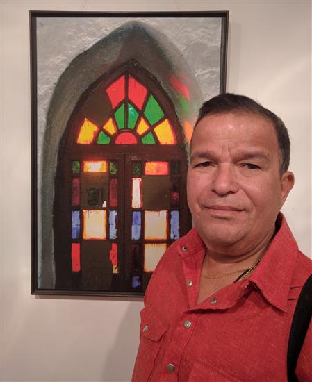 Artist Gajanan Dandekar with a picture from the show Call of the Hills
