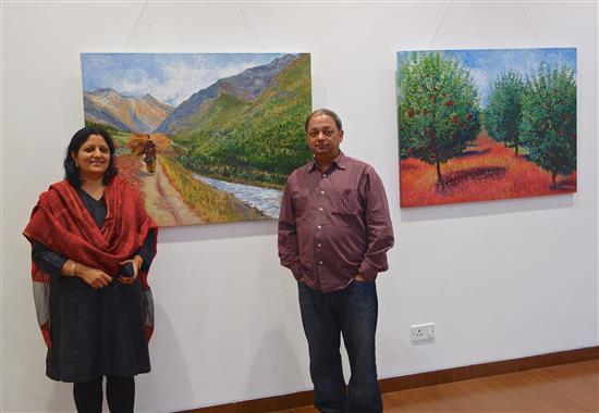 Chitra Vaidya and Milind Sathe with paintings from the show Call of the Hills at Nehru Centre, Mumbai