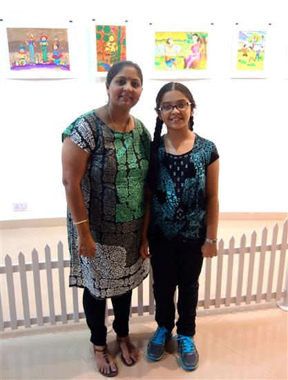 Participating child artist with parent at the gallery