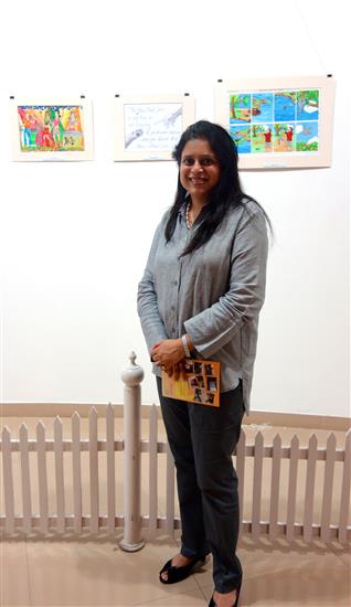 A proud parent with the child's painting in the background