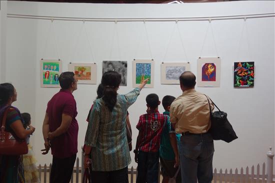 Paintings on display being keenly observed