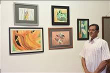 Vishnu Bhatwadekar with his paintings at the Emerging Artists show presented by Indiaart.com at Nehru Centre, Mumbai