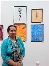 Nandita Sharma with her paintings at the Emerging Artists show by Indiaart.com