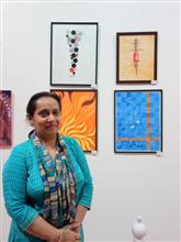 Nandita Sharma with her paintings at the Emerging Artists show by Indiaart.com
