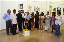 Prof. Pitkar lighting the lamp at the Emerging Artists show presented by Indiaart.com at Nehru Centre, MUmbai