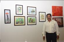 Narendra Gangakhedkar with his paintings at the Emerging Artists show presented by Indiaart.com at Nehru Centre, Mumbai