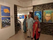 Dr. Shriram Lagoo and Deepa Lagoo looking at the paintings at Indiaart Gallery  