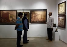 Shri Yashwant Shirwadkar talking to guests at Indiaart Gallery