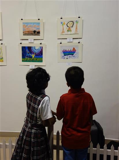 Chinmayee Naravane talks about her painting to another child 