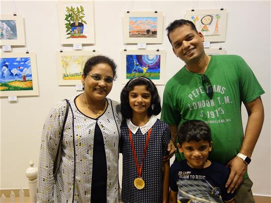  Riya Bhat with her family in front of her painting at Khula Aasmaan exhibition at Mumbai - October 2017