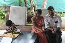 Young Shrutika paints, with parents at Indiaart Gallery 