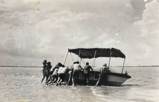 A jet boat from Sir Edmund Hillary's India - New Zealand expedition on the Ganges that hit a sandbar in the middle of the mighty river, photograph by Prem Vaidya
