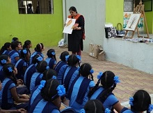 Chitra Vaidya discussing the leaf and its painting with the girl students at the painting workshop