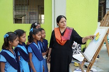 Girl students with Chitra Vaidya during art workshop at Warvada ashramshala for girls