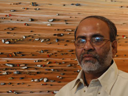 Artist Shamendu Sonawane with his paintings