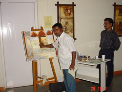 Artist Dinkar Jadhav with his paintings