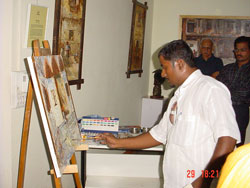 Artist Dinkar Jadhav with his paintings