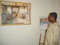 Artist Dinkar Jadhav with his paintings