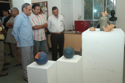 Visitors viewing sculptures made during ceramic camp