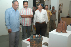 Visitors viewing sculptures made during ceramic camp