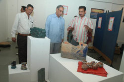 Visitors viewing sculptures made during ceramic camp