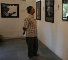 Visitor looking at Jake's Charcoal Drawings