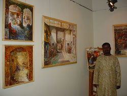 Artist Dinkar Jadhav with his paintings