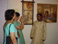 Artist Dinkar Jadhav with his paintings