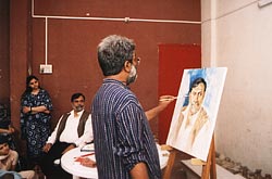 Vasudeo Kamath painting the model