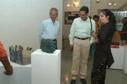Visitors viewing sculptures made during ceramic camp