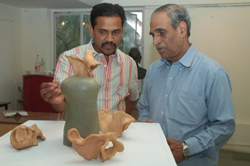 Visitors viewing sculptures made during ceramic camp