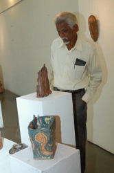 Visitors viewing sculptures made during ceramic camp