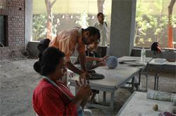 Sculptors working on creating sculptures in ceramics