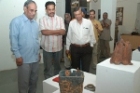  Visitors viewing sculptures made during ceramic camp