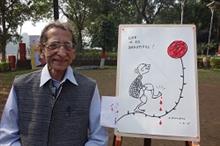 S. D. (Shi Da) Phadnis with his finished cartoon drawing