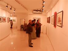 Chitra Vaidya showing her paintings to visitors