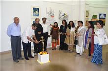 Ar. Vishnu Bhatwadekar lighting the lamp at the Emerging Artists show presented by Indiaart.com at Nehru Centre, Mumbai