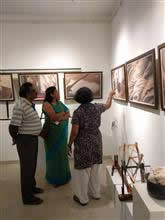 Latha discussing the exhibits with the visitors to the show Cotton to cloth   