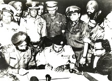 Lt. Gen. A.A.K. Niazi, Commander, Eastern Command, Pakistan, signing the Instrument of Surrender at Dacca on December 16, 1971. By his side is Lt. Gen. Jagjit Singh Aur, Photo by Prem Vaidya